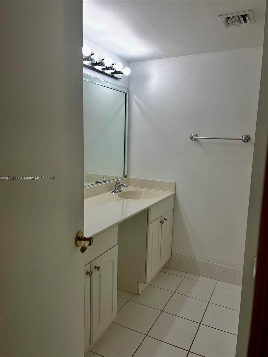 6800 Cypress Road, Unit 408 Plantation, FL 33317 - Photo 14 of 25 a bathroom with a sink vanity and mirror