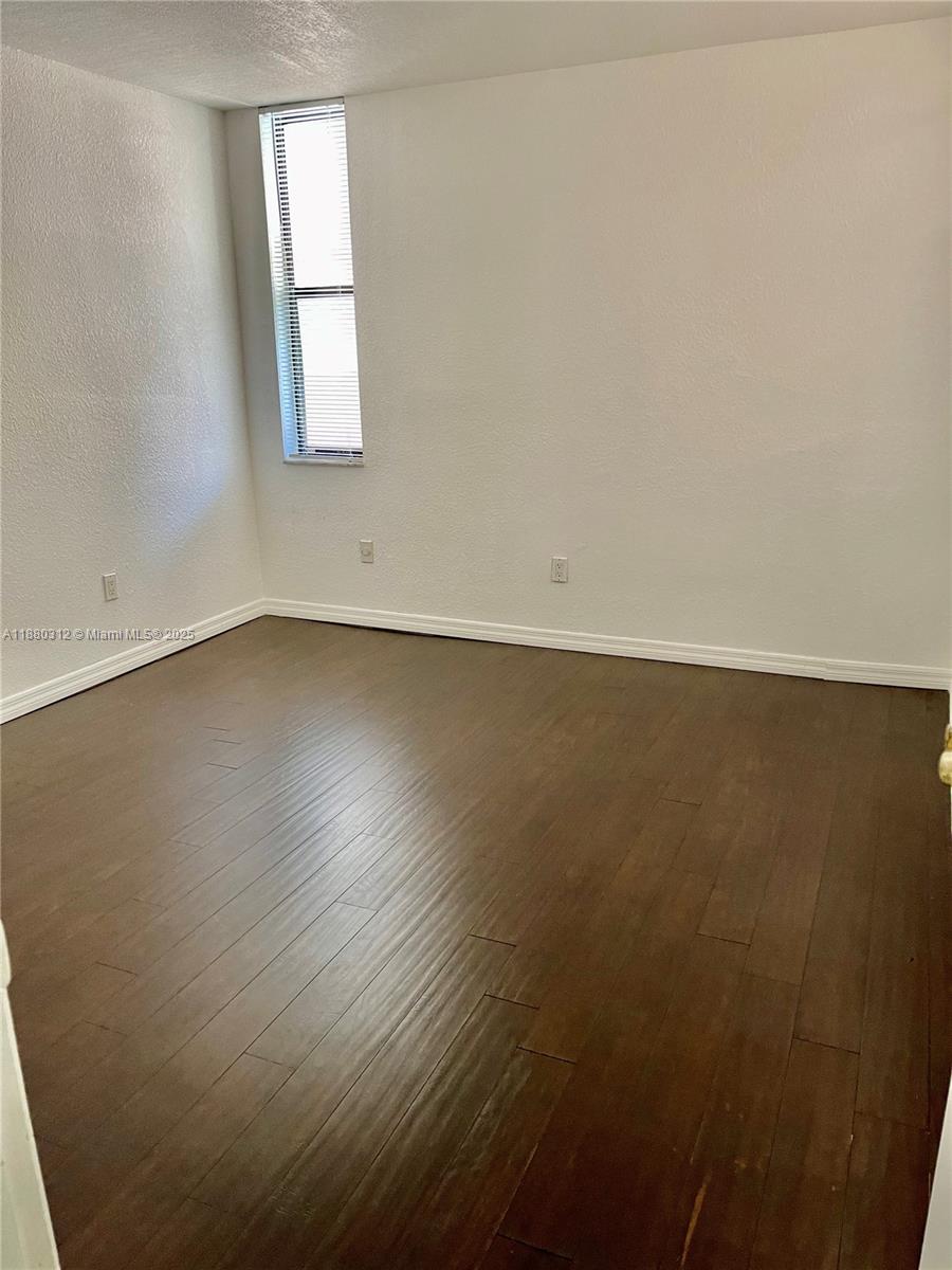 6800 Cypress Road, Unit 408 Plantation, FL 33317 - Photo 16 of 25 an empty room with wooden floor and windows