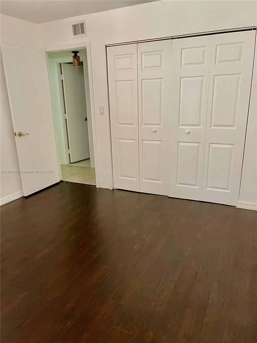 6800 Cypress Road, Unit 408 Plantation, FL 33317 - Photo 17 of 25 an empty room with wooden floor