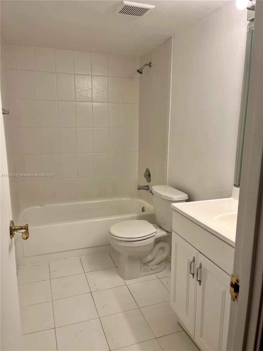 6800 Cypress Road, Unit 408 Plantation, FL 33317 - Photo 18 of 25 a bathroom with a toilet sink and shower
