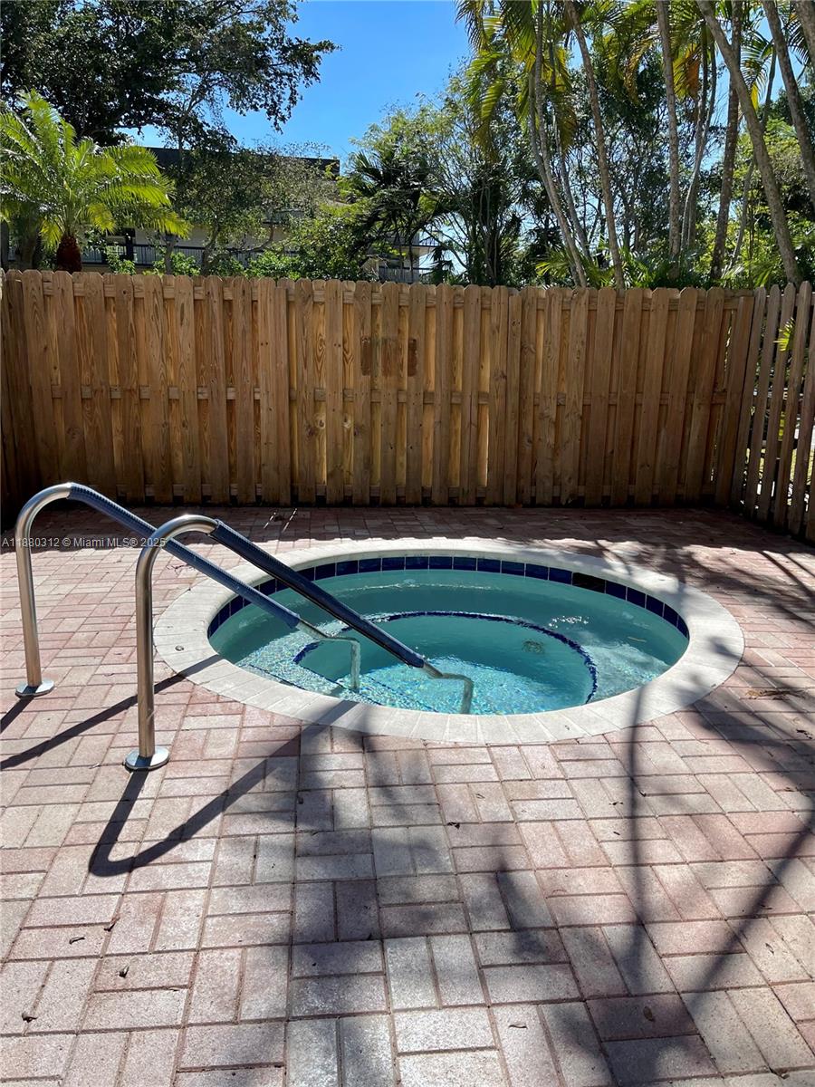 6800 Cypress Road, Unit 408 Plantation, FL 33317 - Photo 22 of 25 a swimming pool with some trees in the background