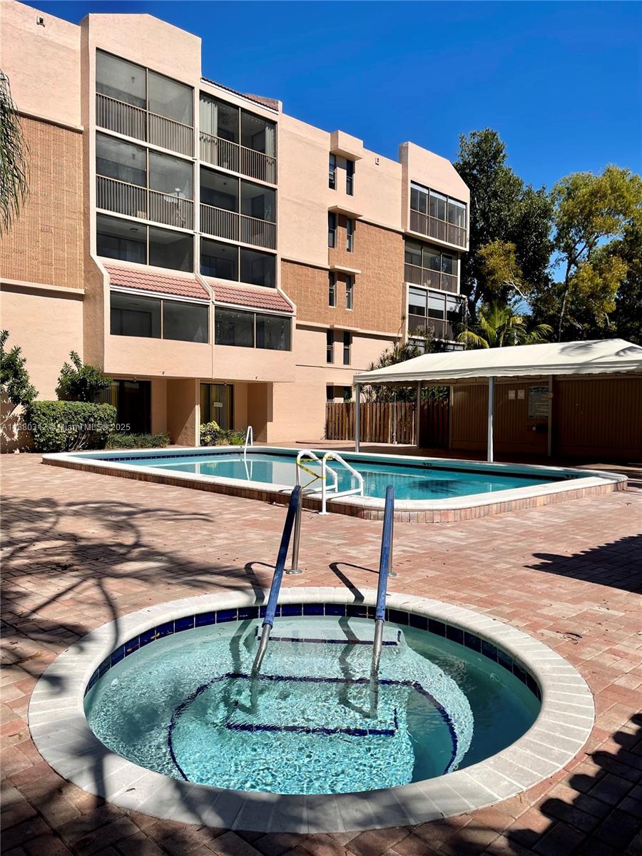 6800 Cypress Road, Unit 408 Plantation, FL 33317 - Photo 23 of 25 a swimming pool with outdoor seating