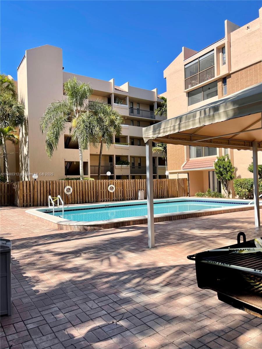 6800 Cypress Road, Unit 408 Plantation, FL 33317 - Photo 24 of 25 a view of a building with floor to ceiling windows and a city view