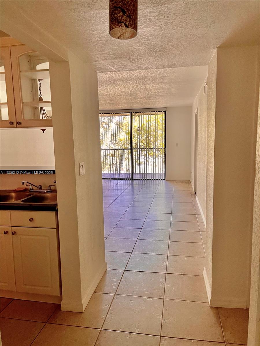 6800 Cypress Road, Unit 408 Plantation, FL 33317 - Photo 4 of 25 a view of a kitchen with an empty space and a window