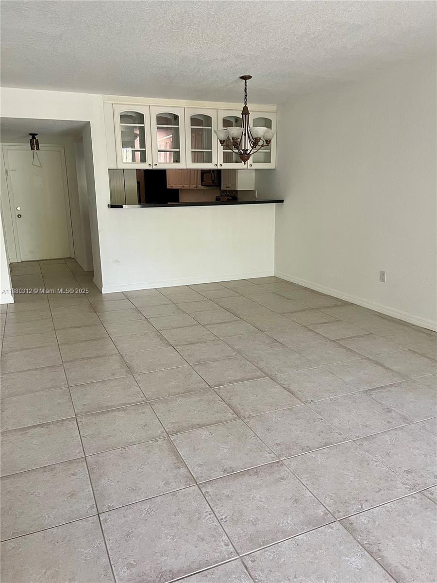 6800 Cypress Road, Unit 408 Plantation, FL 33317 - Photo 6 of 25 a view of living room with stainless steel appliances cabinets and rug