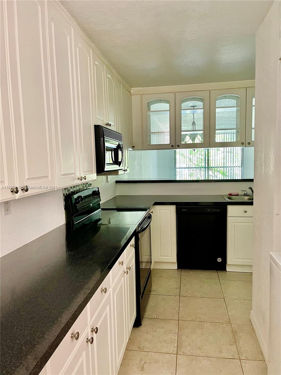 6800 Cypress Road, Unit 408 Plantation, FL 33317 - Photo 7 of 25 a kitchen with stainless steel appliances granite countertop a stove and a sink