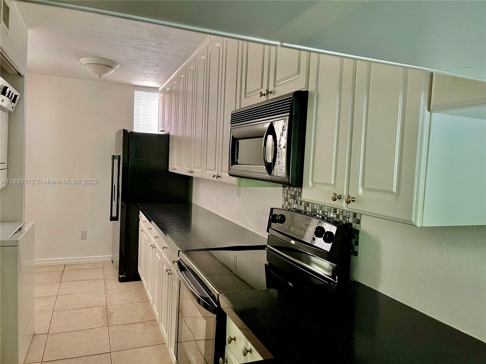 6800 Cypress Road, Unit 408 Plantation, FL 33317 - Photo 8 of 25 a kitchen with a sink appliances and cabinets