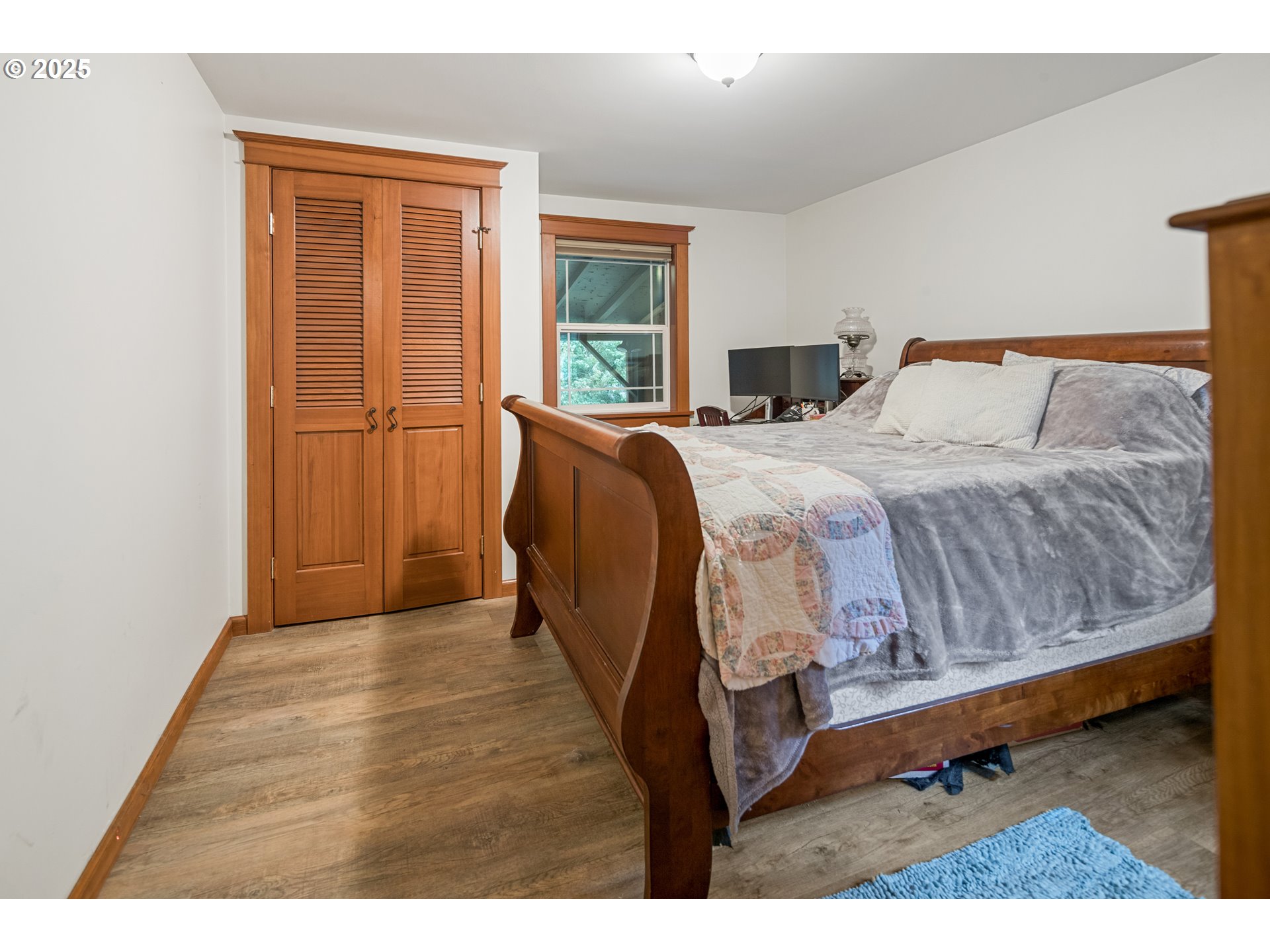 16326 Butteville Road Northeast Woodburn, OR 97071 - Photo 16 of 48 a bedroom with a bed and wooden floor