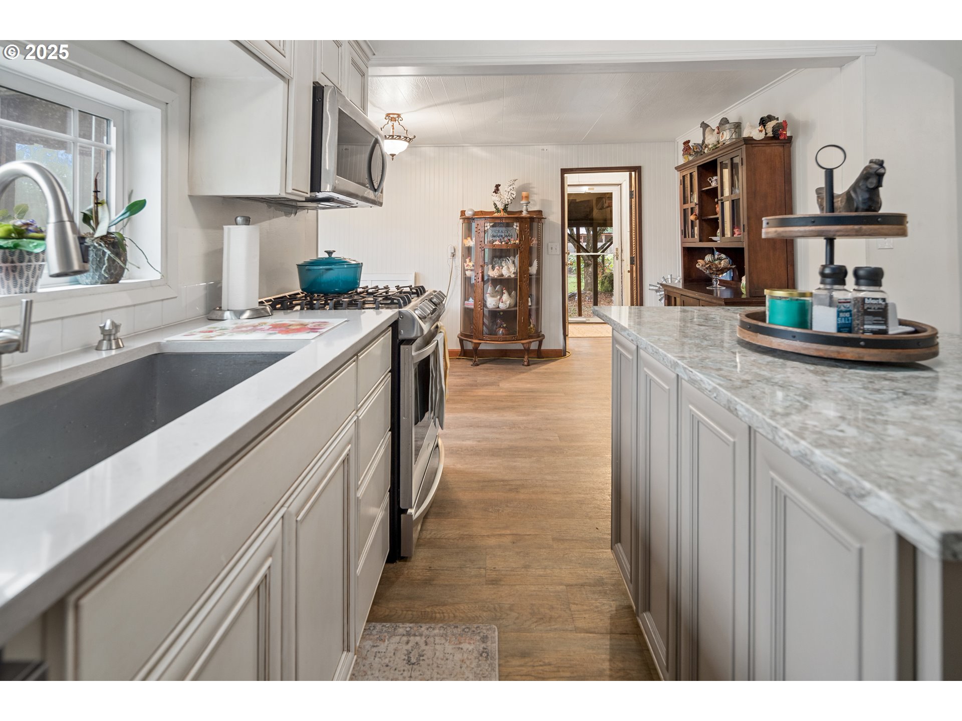 16326 Butteville Road Northeast Woodburn, OR 97071 - Photo 25 of 48 a kitchen with stainless steel appliances granite countertop a sink stove and refrigerator