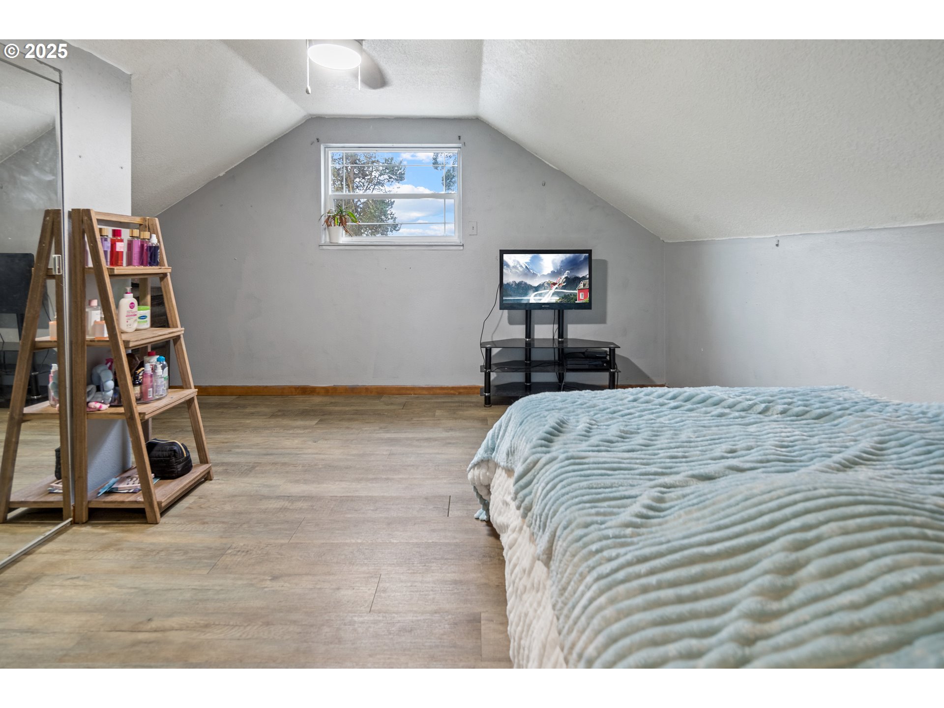 16326 Butteville Road Northeast Woodburn, OR 97071 - Photo 29 of 48 a bedroom with a bed and a flat screen tv