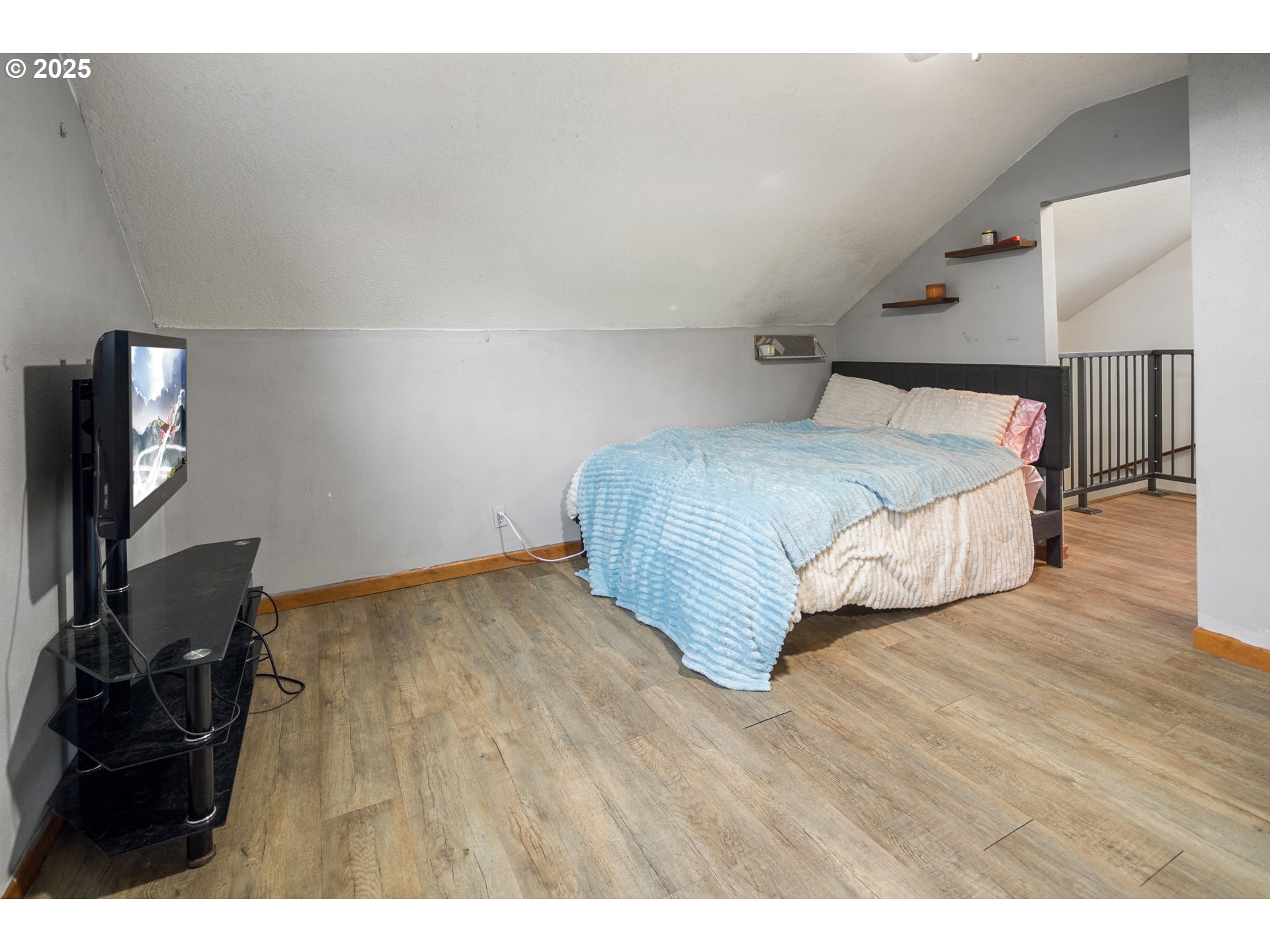 16326 Butteville Road Northeast Woodburn, OR 97071 - Photo 30 of 48 a bedroom with a bed and a flat tv screen on the dresser