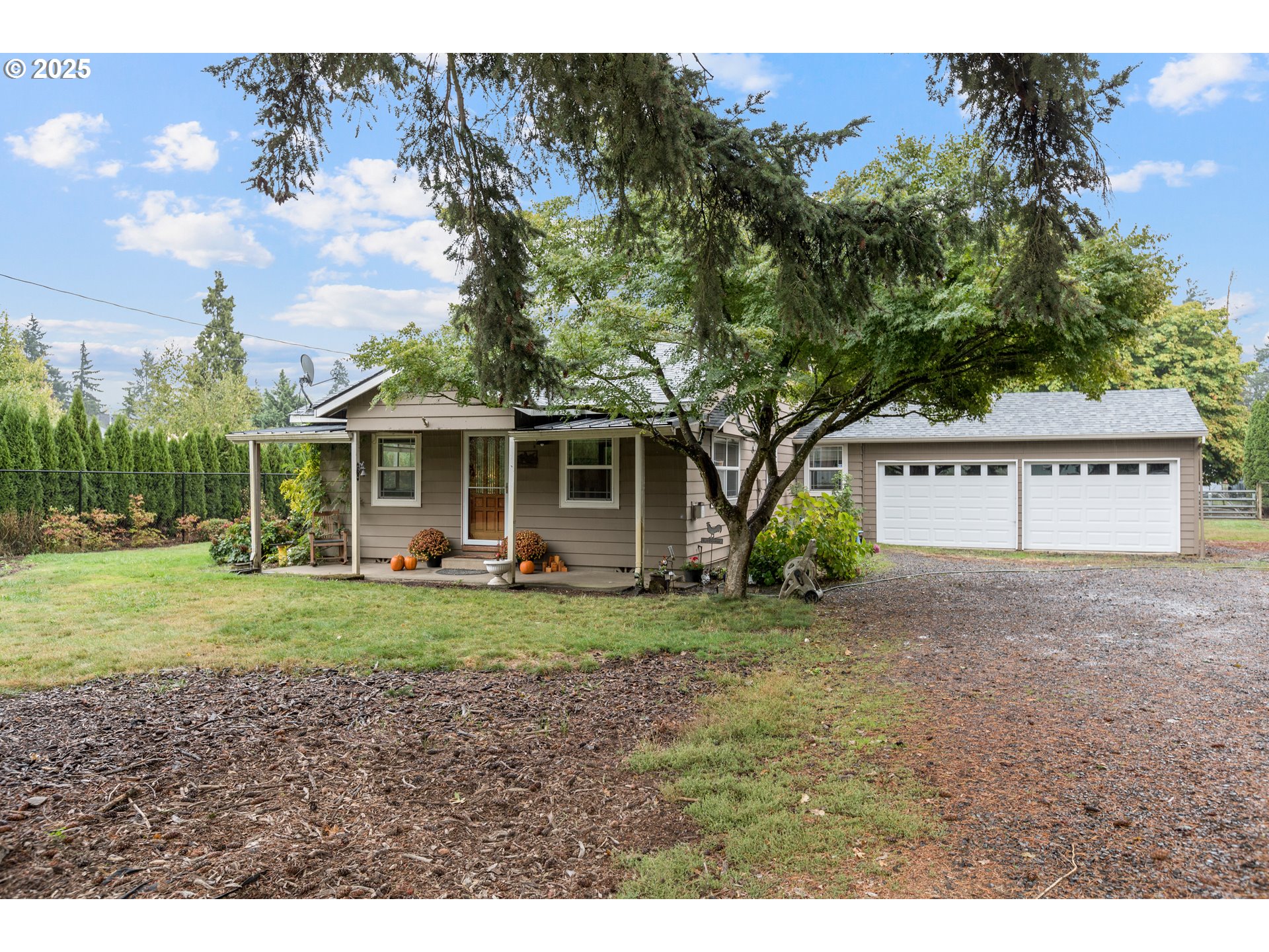 16326 Butteville Road Northeast Woodburn, OR 97071 - Photo 3 of 48 a view of a house with a yard and large tree