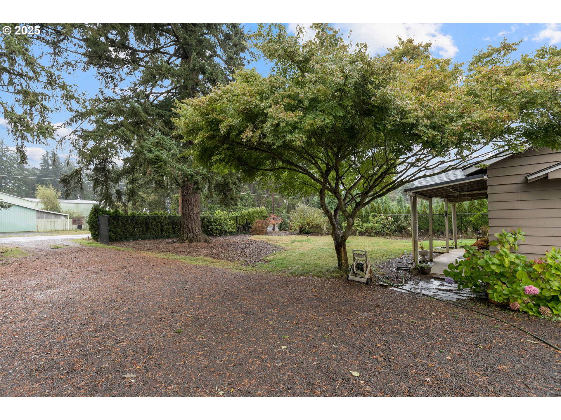 16326 Butteville Road Northeast Woodburn, OR 97071 - Photo 37 of 48 a view of a yard with plants and trees