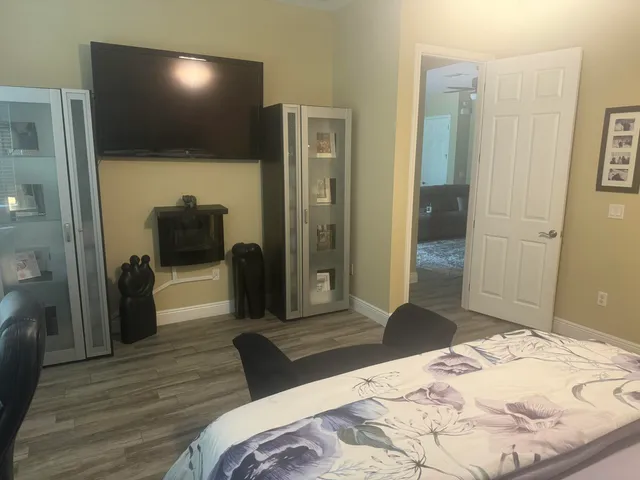 a bedroom with a bed and a flat screen tv