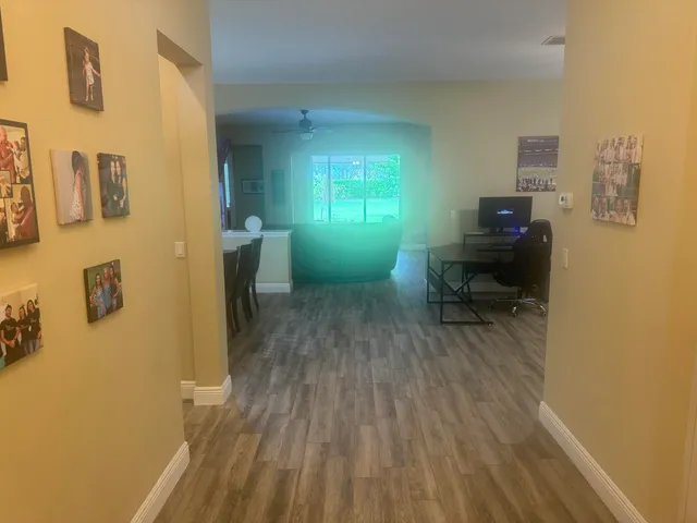 a room with wooden floor and furniture