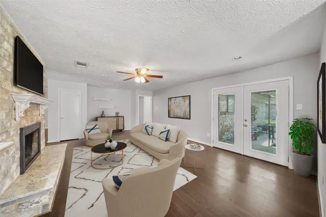 a living room with furniture a flat screen tv and a fireplace