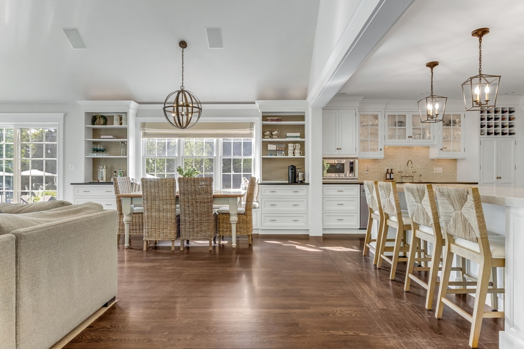 85 Old Farm Road Milton, MA 02186 - Photo 6 of 42 a view of a dining room and livingroom with furniture wooden floor a chandelier