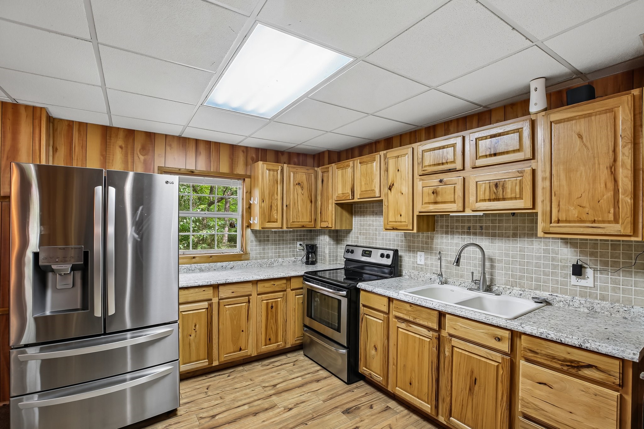 164 Frank Road Trinity, TX 75862 - Photo 15 of 20 Another angle of the kitchen highlights the ample storage and breakfast bar seating, making this the perfect hub for morning coffee or casual family meals.
