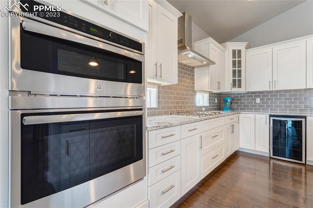11590 Spectacular Bid Circle Colorado Springs, CO 80921 - Photo 13 of 49 a kitchen with granite countertop white cabinets stainless steel appliances and sink