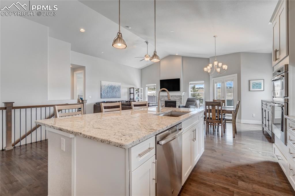 11590 Spectacular Bid Circle Colorado Springs, CO 80921 - Photo 15 of 49 a kitchen with lots of counter space a sink dining table and chairs
