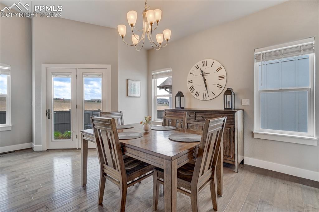 11590 Spectacular Bid Circle Colorado Springs, CO 80921 - Photo 17 of 49 a view of a dining room with furniture wooden floor and a chandelier