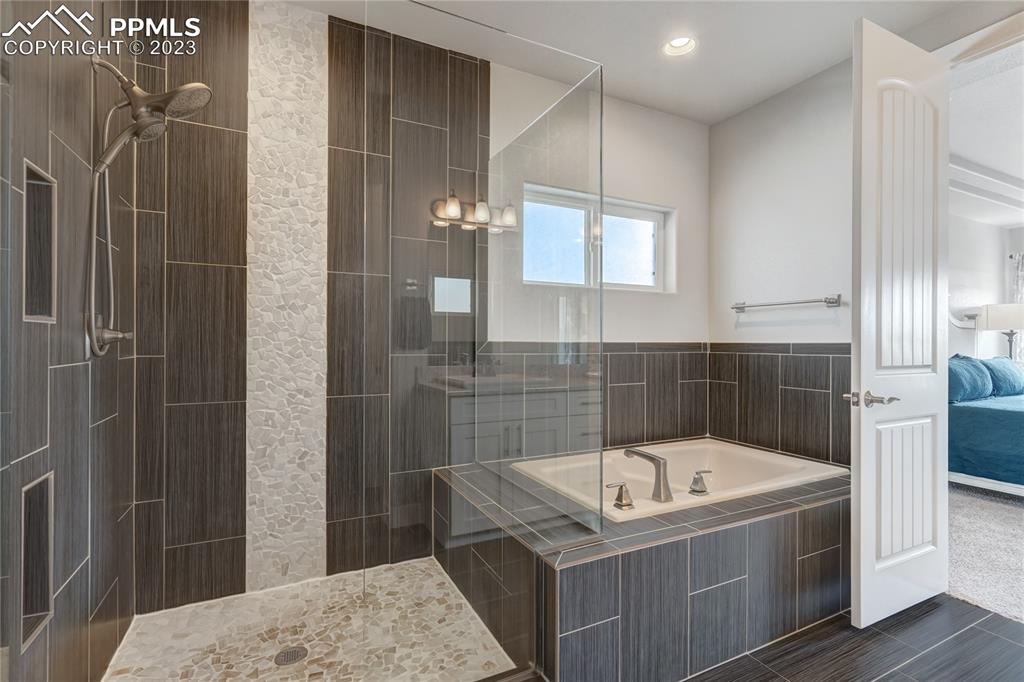 11590 Spectacular Bid Circle Colorado Springs, CO 80921 - Photo 23 of 49 a bathroom with a bathtub and shower
