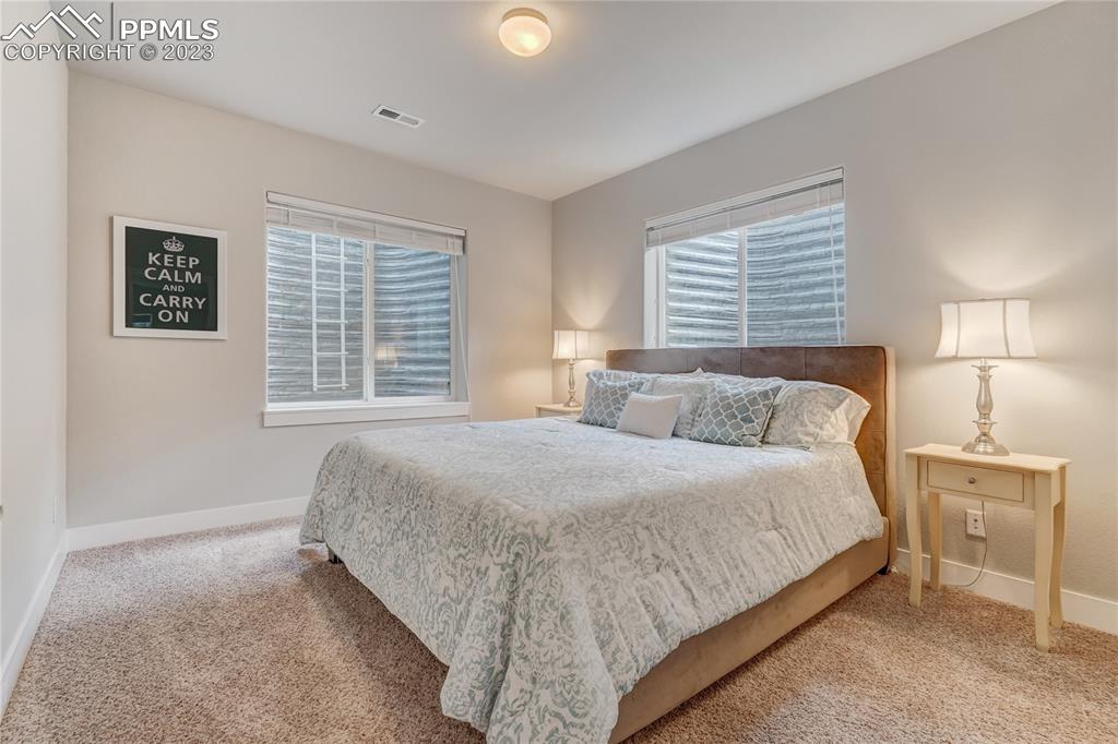 11590 Spectacular Bid Circle Colorado Springs, CO 80921 - Photo 30 of 49 a bedroom with a bed and a lamp