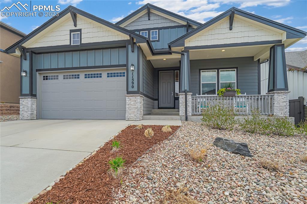 11590 Spectacular Bid Circle Colorado Springs, CO 80921 - Photo 3 of 49 a front view of a house with garden
