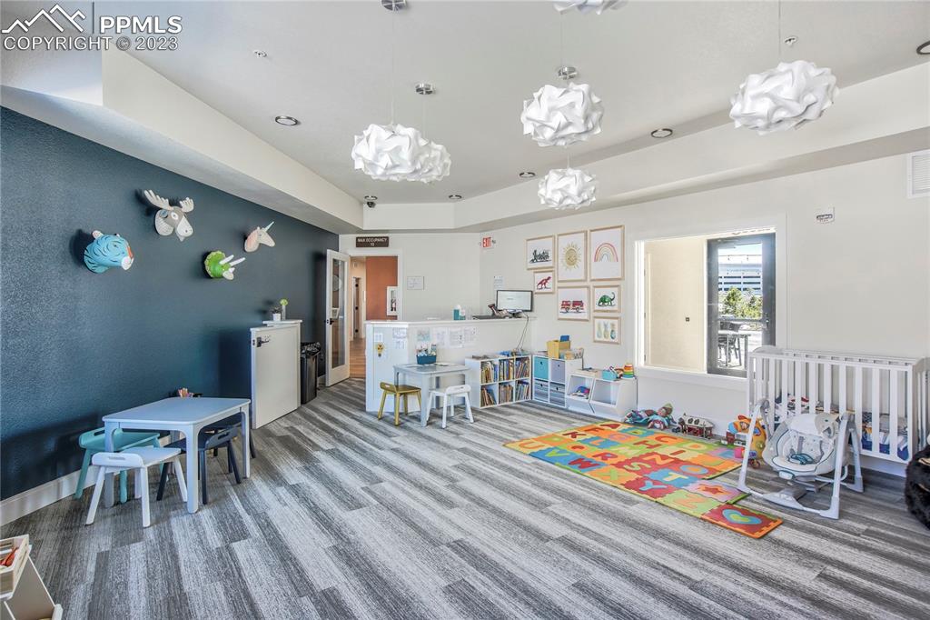 11590 Spectacular Bid Circle Colorado Springs, CO 80921 - Photo 44 of 49 a living room with dining room and wooden floor