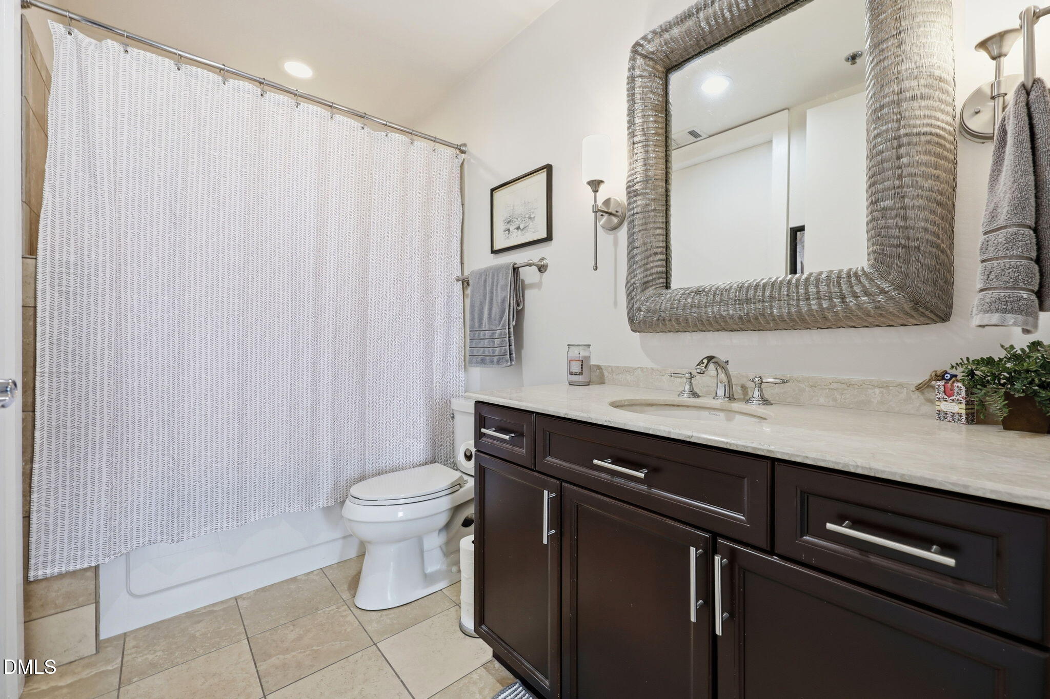 618 North Boylan Avenue, Unit 718 Raleigh, NC 27603 - Photo 20 of 38 a bathroom with a granite countertop sink a toilet and a mirror