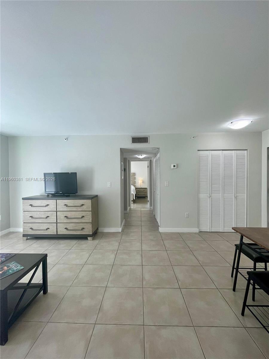 700 Northeast 63rd Street, Unit D203 Miami, FL 33138 - Photo 11 of 36 a living room with furniture and a dining table