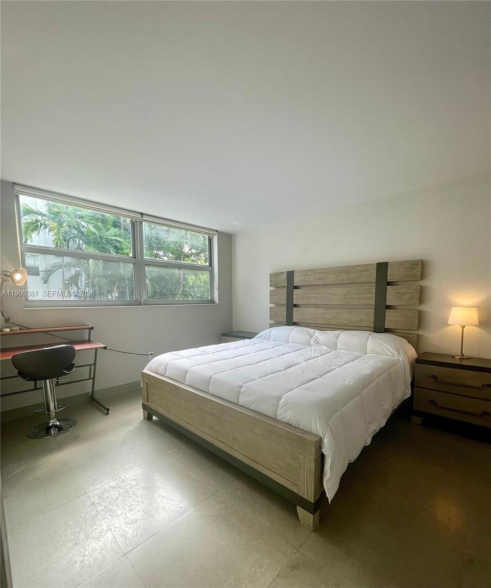 700 Northeast 63rd Street, Unit D203 Miami, FL 33138 - Photo 12 of 36 a bedroom with a bed and a window