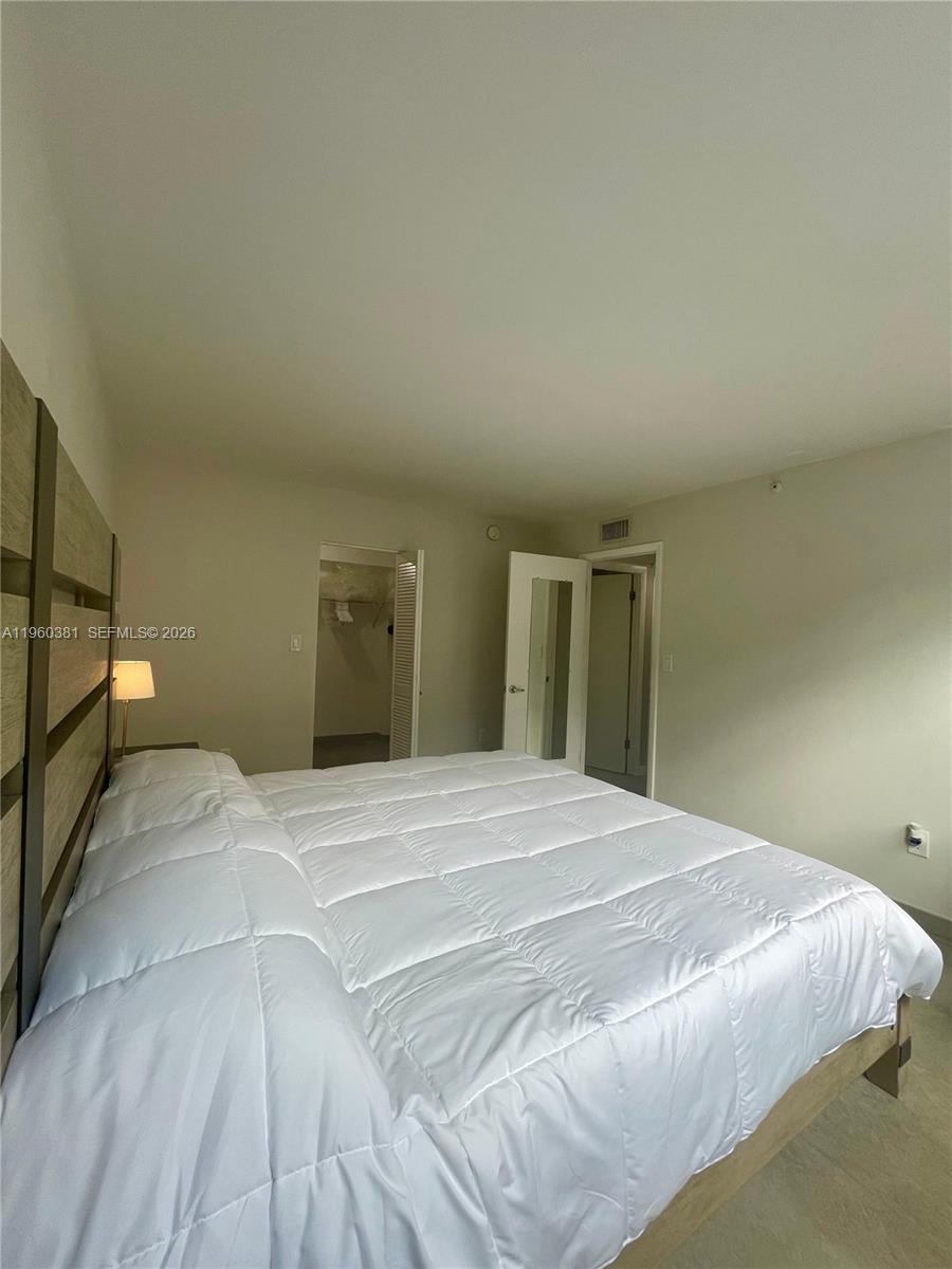 700 Northeast 63rd Street, Unit D203 Miami, FL 33138 - Photo 13 of 36 a bedroom with a bed and a window