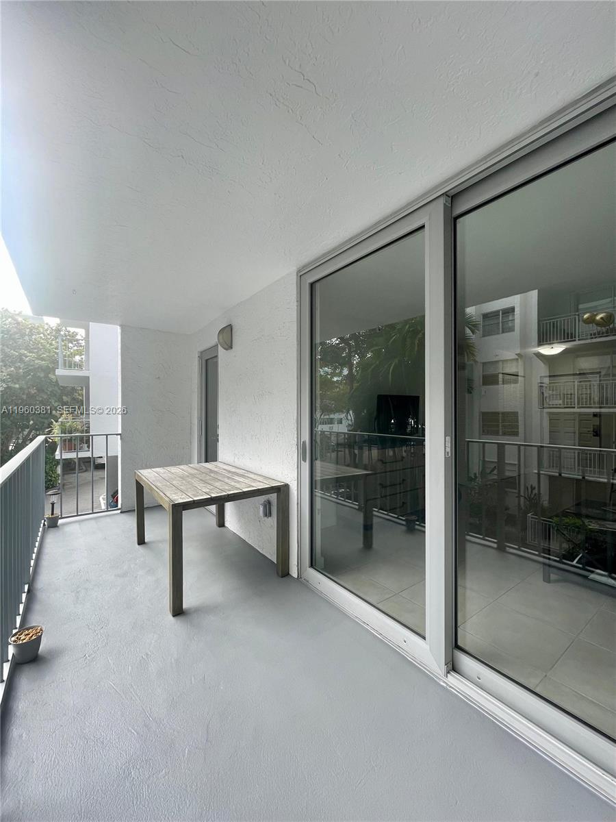700 Northeast 63rd Street, Unit D203 Miami, FL 33138 - Photo 22 of 36 a view of a livingroom with furniture and window
