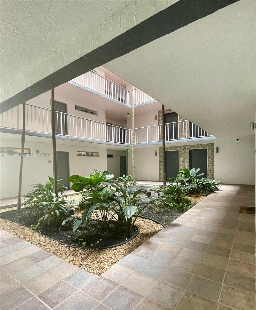 700 Northeast 63rd Street, Unit D203 Miami, FL 33138 - Photo 23 of 36 a front view of a house with garden