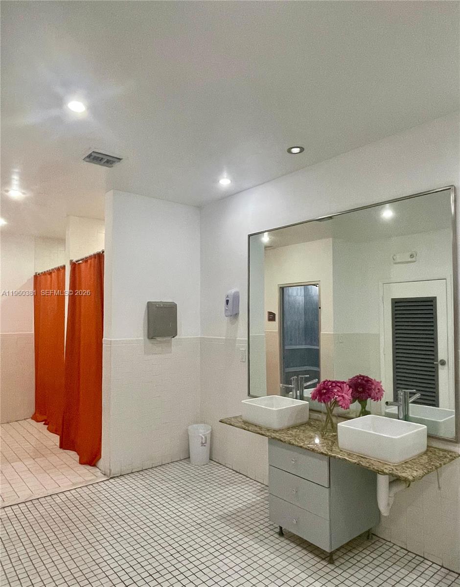 700 Northeast 63rd Street, Unit D203 Miami, FL 33138 - Photo 36 of 36 a living room with stainless steel appliances kitchen island granite countertop wooden cabinets and couch