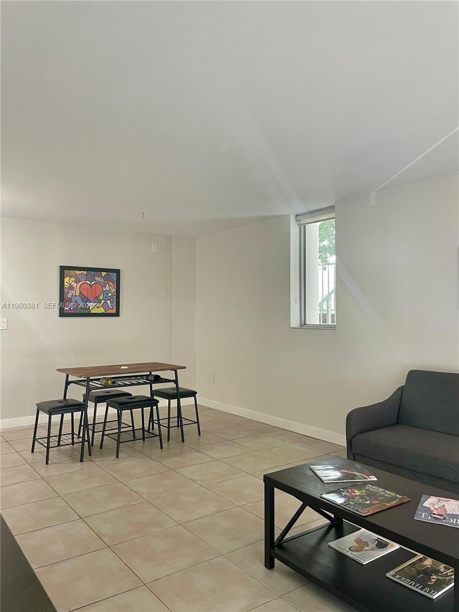 700 Northeast 63rd Street, Unit D203 Miami, FL 33138 - Photo 6 of 36 a living room with furniture
