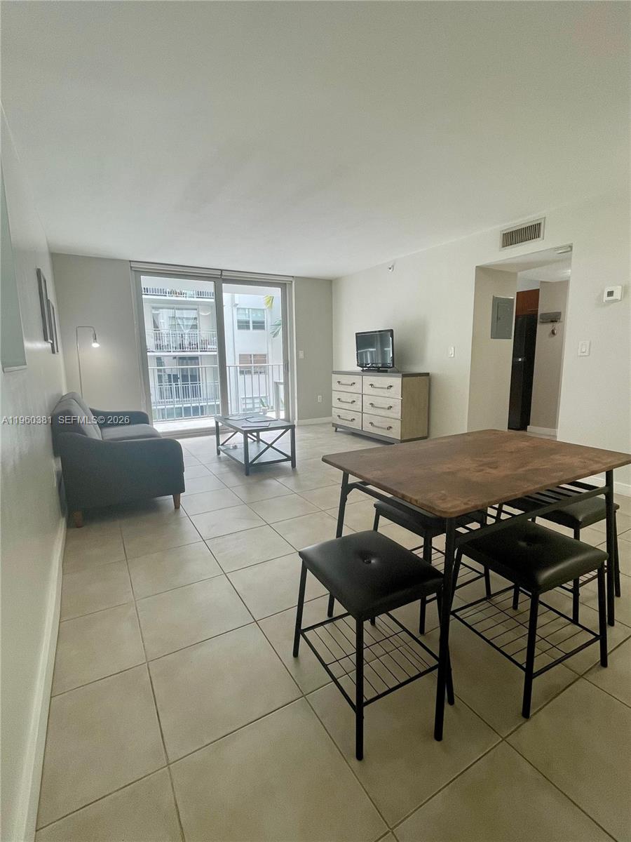 700 Northeast 63rd Street, Unit D203 Miami, FL 33138 - Photo 10 of 36 a living room with furniture a table and a window