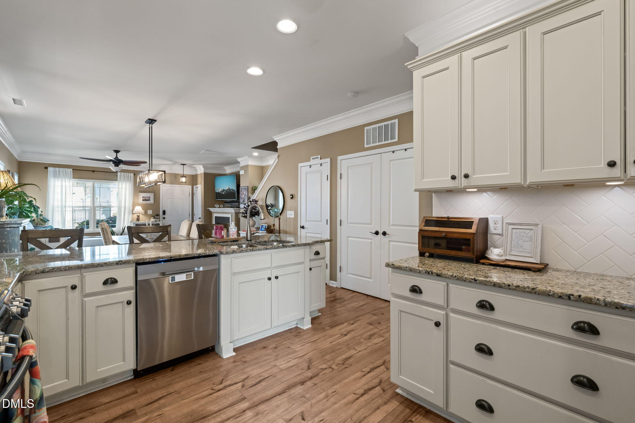 1716 Main Divide Drive Wake Forest, NC 27587 - Photo 15 of 45 a kitchen with granite countertop a sink cabinets stainless steel appliances and wooden floor