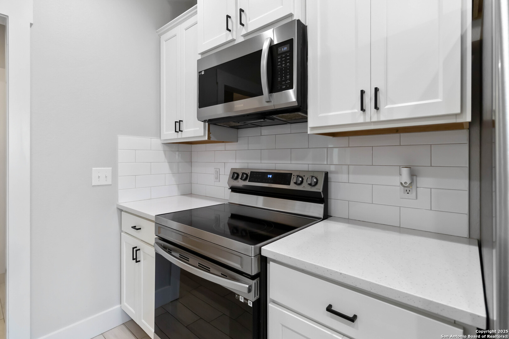 119 Rockingshire Court Spring Branch, TX 78070 - Photo 12 of 34 a kitchen with stainless steel appliances white cabinets and a stove top oven