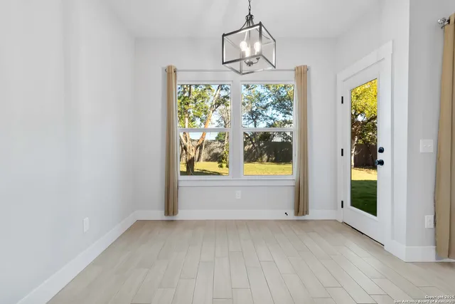 an empty room with windows and outdoor view