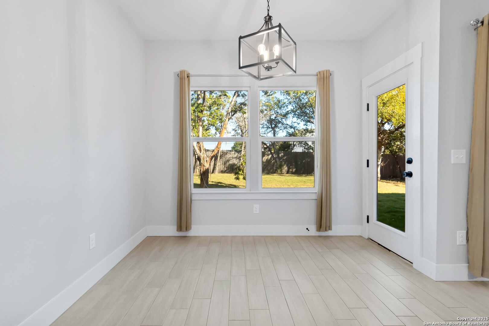119 Rockingshire Court Spring Branch, TX 78070 - Photo 13 of 34 an empty room with windows and outdoor view