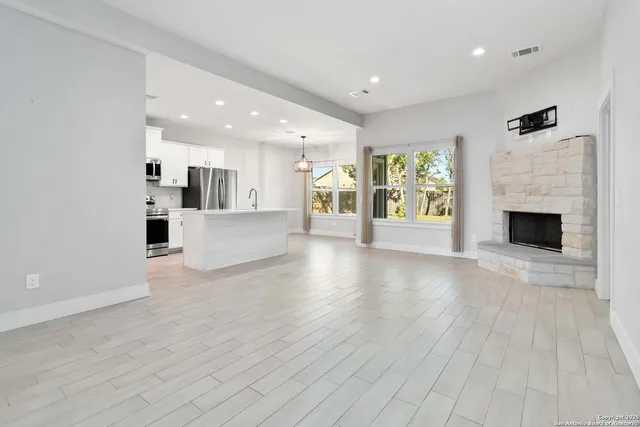 a view of a kitchen with a dishwasher cabinets and a fireplace