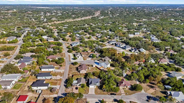 an aerial view of a house with a yard and garden
