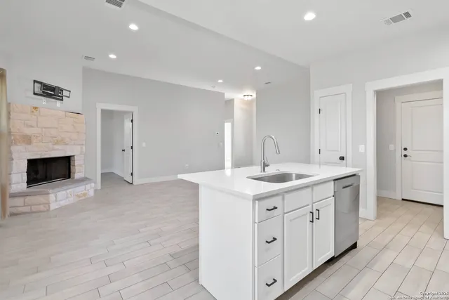 a kitchen with a sink stove and cabinets