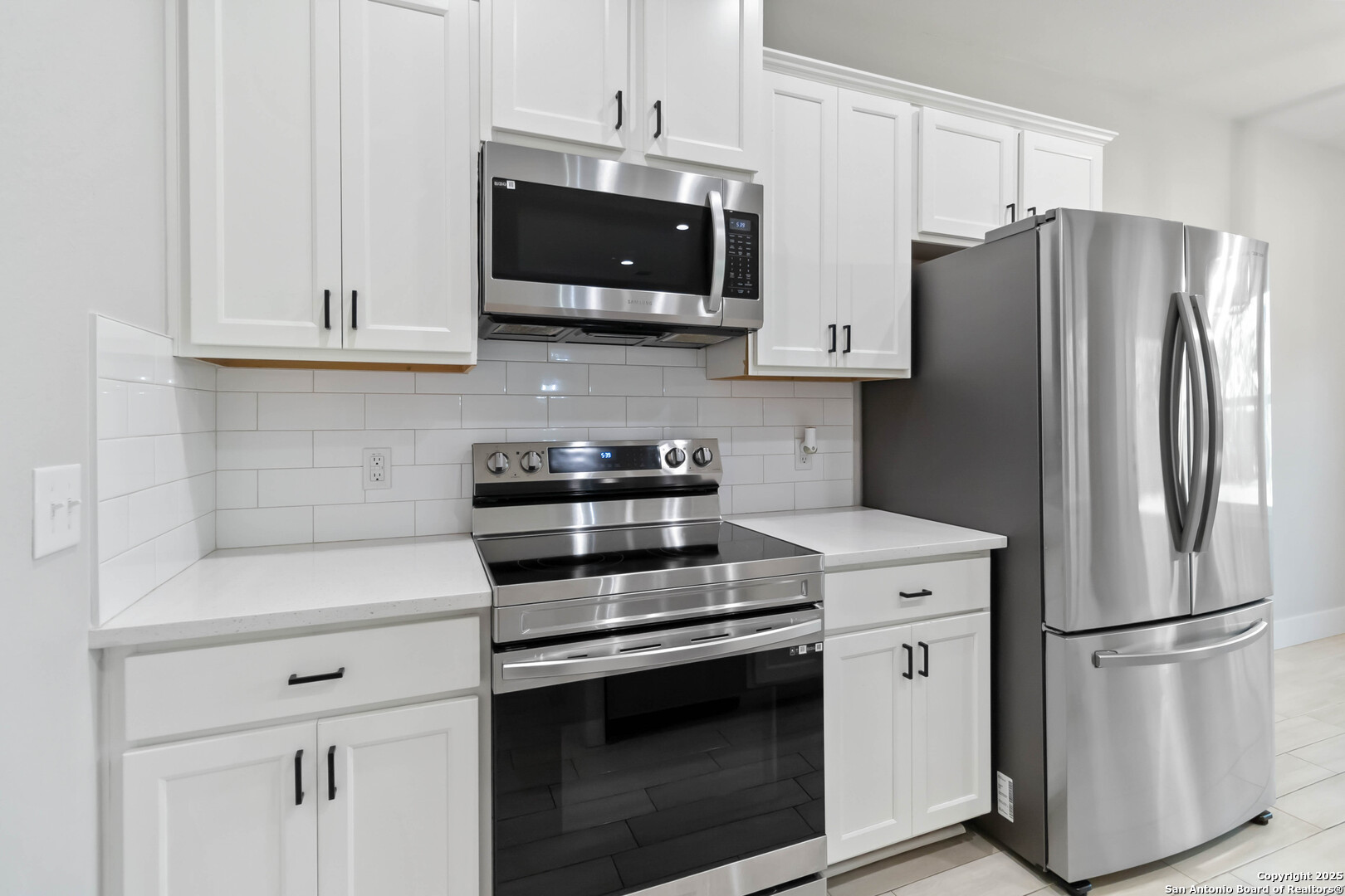 119 Rockingshire Court Spring Branch, TX 78070 - Photo 10 of 34 a kitchen with stainless steel appliances white cabinets white stove a microwave and a refrigerator