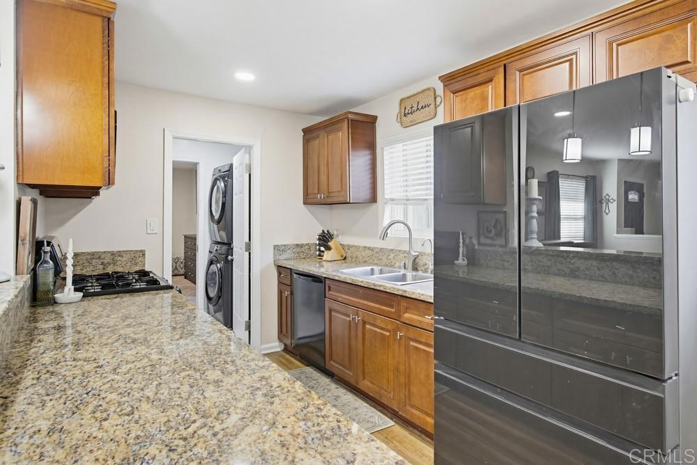 8838 Innsdale Avenue Spring Valley, CA 91977 - Photo 12 of 38 a kitchen with stainless steel appliances granite countertop a refrigerator and a sink