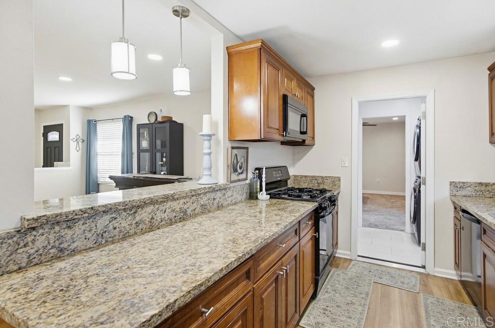 8838 Innsdale Avenue Spring Valley, CA 91977 - Photo 13 of 38 a kitchen with stainless steel appliances granite countertop a sink and a stove