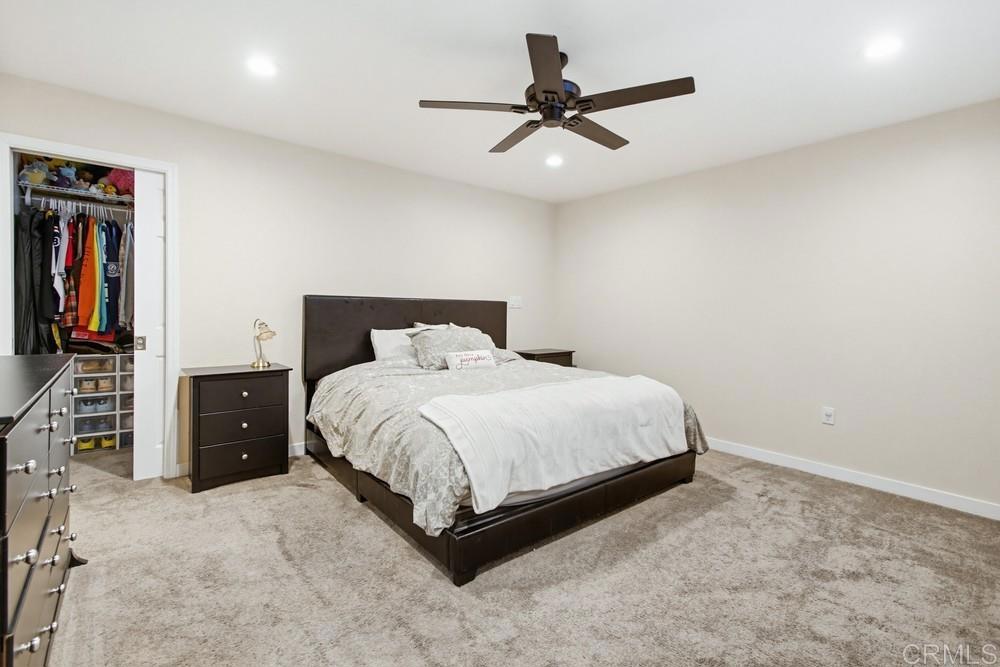 8838 Innsdale Avenue Spring Valley, CA 91977 - Photo 19 of 38 a bedroom with a bed and a walk in closet