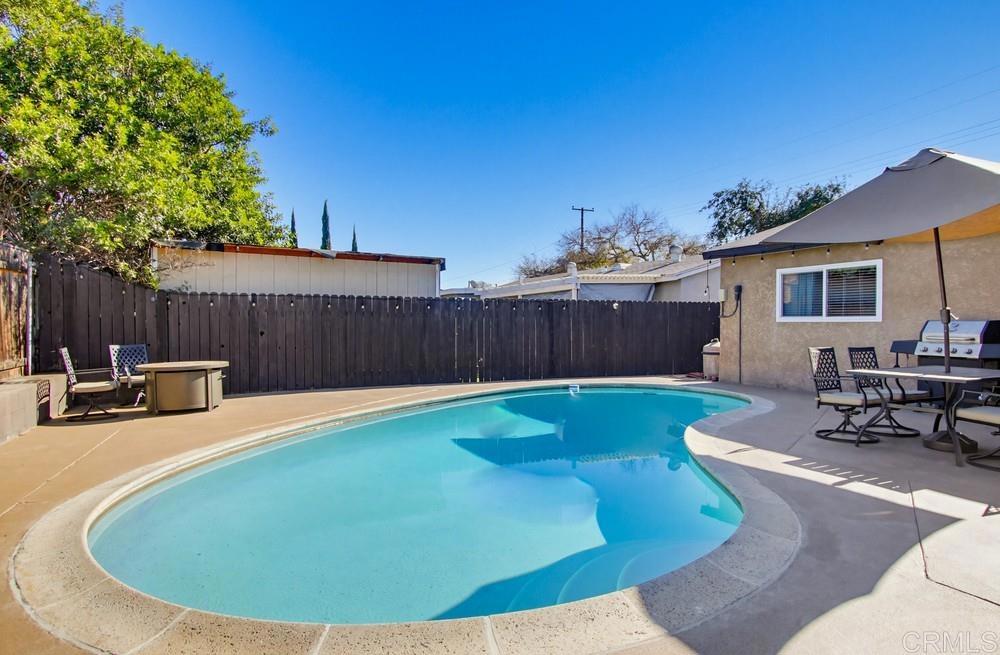 8838 Innsdale Avenue Spring Valley, CA 91977 - Photo 29 of 38 a view of a backyard with table and chairs with wooden fence